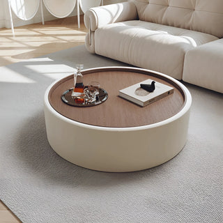 Cream white round coffee table with North American walnut veneer top in bright modern interior