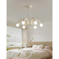 Cream modern chandelier in bright minimalist bedroom interior with soft neutral decor