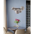 Smoked glass globe chandelier above modern dining table in contemporary interior
