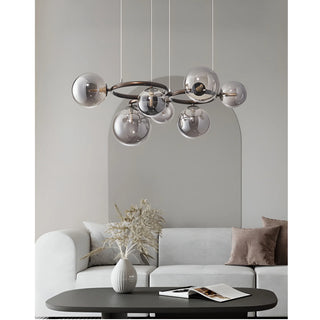 Minimalist smoked glass globe chandelier above modern sofa and coffee table