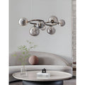 Modern smoked glass globe chandelier styled above contemporary living room seating area
