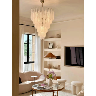 Modern textured glass tiered chandelier hanging in an elegant contemporary living room