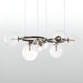 Modern clear glass globe chandelier with circular bronze frame and spherical glass shades