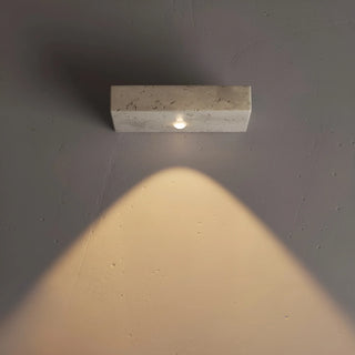 modern interior with travertine rectangular wall sconces casting warm upward light