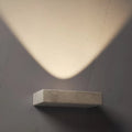 modern interior with travertine wall sconces casting warm upward light