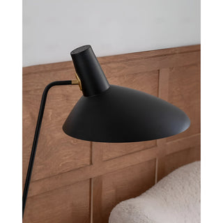 Close-up of modern tripod floor lamp metal shade and adjustable head