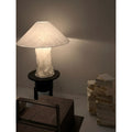 Modern wabi-sabi paper table lamp with textured sculptural base creating soft ambient lighting in minimalist interior