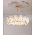 Luxury round white glass chandelier with sculptural layered discs and brass suspension details