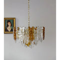 Luxury Murano glass chandelier with amber accents suspended in a contemporary interior