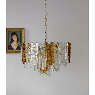 Luxury Murano glass chandelier with amber accents suspended in a contemporary interior