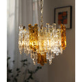 Elegant Murano glass chandelier with amber details near a softly lit window interior