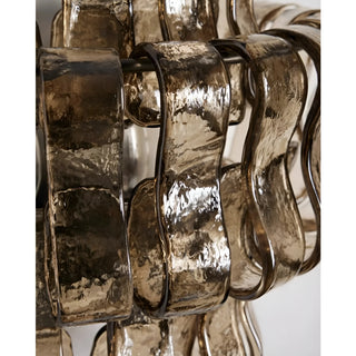 Close-up of smoked Murano glass elements on a luxury modern wall sconce with textured artisan glass finish