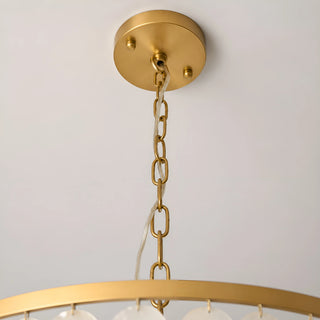 Detail of the Nacara chandelier's brushed brass ceiling canopy and adjustable chain