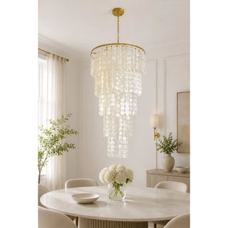 Nacara capiz shell cascade chandelier above a round dining table with white hydrangeas