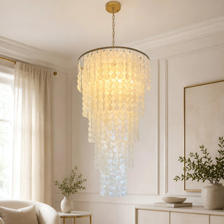 Nacara capiz shell chandelier with a brass canopy glowing warmly in a modern living room
