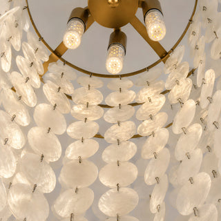 Detail of the Nacara chandelier's E14 LED bulbs framed by tiers of capiz shell discs