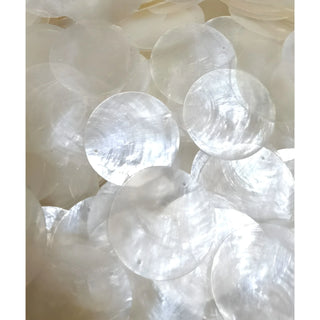 Close-up detail of genuine capiz shell discs showcasing their natural pearlescent texture and translucent finish