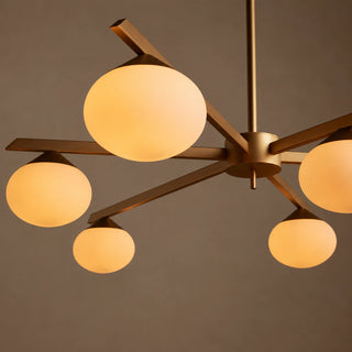 Novara brass opal-globe chandelier seen from below showing the radial arms and lit globes