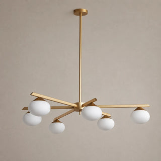 Novara brass six-light opal-globe chandelier unlit, angled studio view