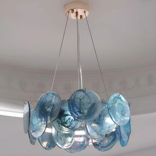 Ocean blue round glass chandelier with layered textured discs in luxury interior space