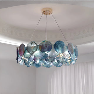Ocean blue round glass chandelier with layered sculptural discs in modern upscale space