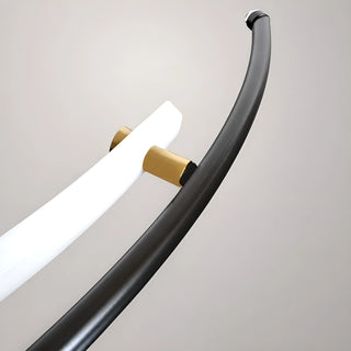 Close-up detail of the Ondara curved chandelier arm and integrated PMMA light-guide tube with polished brass connectors