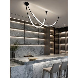 Black Ondara curved LED chandelier lighting a grey marble bar in a modern interior
