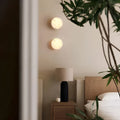 Pair of Spanish onyx sconces creating cozy bedroom ambiance