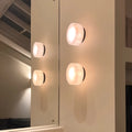 Twin onyx wall sconces with soft warm glow reflected in mirror