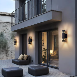 Outdoor wall lights illuminating the terrace of a modern home at dusk