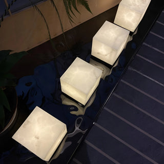 Elegant pathway lighting with imitation marble cube lamps, creating a refined modern outdoor ambiance