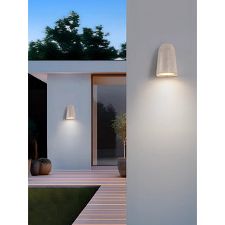 White sandstone microcement wall lamp illuminating a modern villa exterior