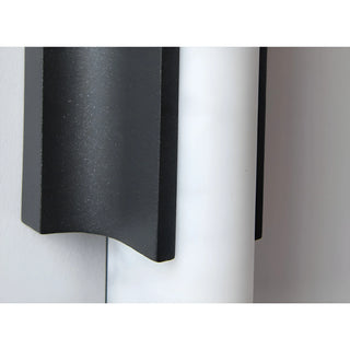 Close-up of sand black stainless steel and resin texture on modern outdoor wall light