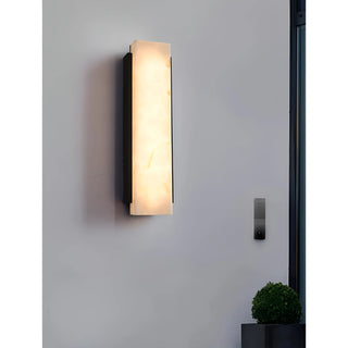 Exterior modern wall sconce mounted outdoors in daylight, minimalist architectural style