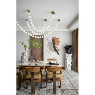 Luxury dining room with French pearl necklace chandelier and marble table, modern artistic interior