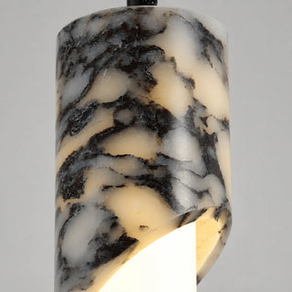 Close-up of the veined marble cylinder cut to reveal the glowing frosted LED tube of the Pietrara pendant