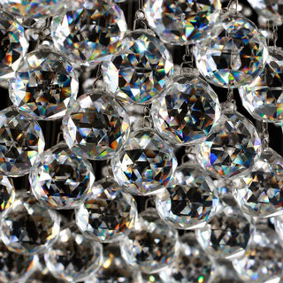 Close-up of the faceted clear crystal balls of the Piovara raindrop chandelier refracting light