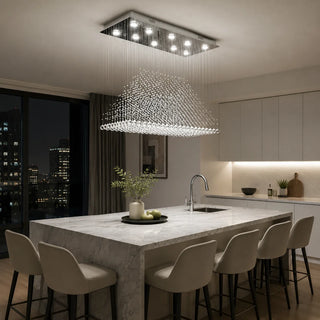 Piovara rectangular crystal chandelier lighting a marble waterfall kitchen island with a city view