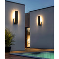 Outdoor wall lights illuminating a poolside area during the evening