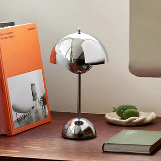 Rechargeable portable mushroom table lamp in polished chrome finish on modern desk
