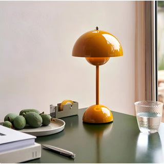 Mustard yellow portable mushroom table lamp with rechargeable LED on modern desk near window