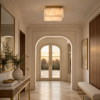 Quadara alabaster flush mount glowing in a warm classic entryway with a brass finish at sunset