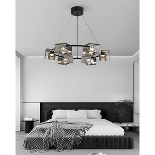 round copper chandelier with textured glass shades above modern black and white bedroom
