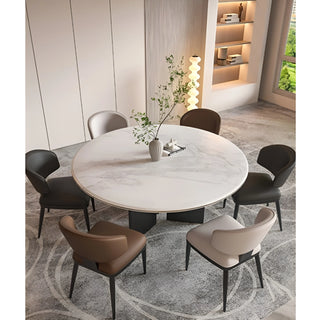 Dining room with round marble table and six luxury dining chairs in neutral tones