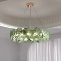 Emerald green round glass chandelier with textured discs in modern luxury interior