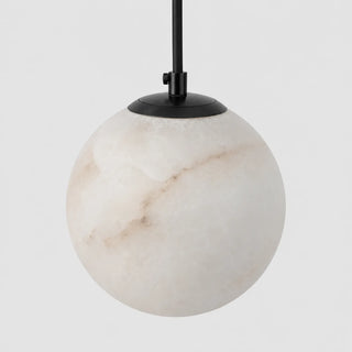 Close-up of the matte black canopy and natural alabaster globe of the Selenara pendant