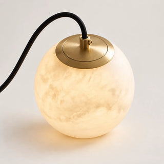 Close-up of the brass canopy and veined alabaster globe of the Selenara pendant