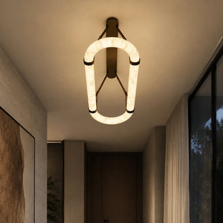 Sellara alabaster oval light seen end-on in a minimalist entryway hallway at dusk