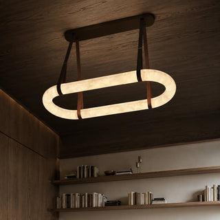 Sellara oval alabaster pendant glowing above a contemporary living space, angled overhead view