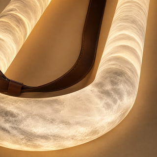 Detail of the translucent natural alabaster tube of the Sellara chandelier with warm internal glow
